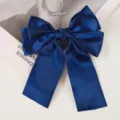 Close-up of navy blue satin bow hair clip with long ribbon tails on white background - Navy Blue