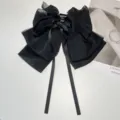 Macro view of a black textured chiffon bow hair claw clip with long elegant ribbons - Chiffon Bow Claw Clip / Black