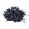 Macro view of black fabric flower hair claw clip with elegant ostrich feathers - Black