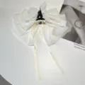 Detailed view of an elegant white tiered chiffon bow hair claw clip with long ribbons - Chiffon Bow Claw Clip / Off White