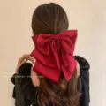 Detailed back view of a large red chiffon bow hair claw clip on wavy brown hair - Satin Bow Claw Clip / Red