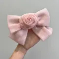 Detailed macro view of delicate pink mesh bow hairclip featuring elegant central rose design - Rose Bow Hair Clip / Pink
