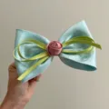 Close-up of glossy satin bow hair clip with pink rose and green ribbons detail. - Spring Clips / Cyan Blue with Rose and Bowknot Spring Clip