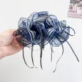 Detail view of navy striped organza ribbon hair claw clip with black streamers - Blue Striped Gauze Bow Hair Claw / Blue