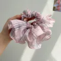 Detailed view of a large pink plaid scrunchie with ruffled skirt design for hair - Plaid Ruffle Style / Pink
