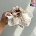 Close-up of a Korean-style oversized ruffled scrunchie with a brown plaid pattern - Plaid Ruffle Style / Yellow