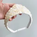 Detailed view of an ivory sequin crown headband with vintage crochet lace textures. - Off-White With Sequin Triangle Style
