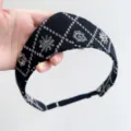 Detail view of black vintage headband with silver embroidered diamond patterns and crown motifs. - Black Embroidered Flower Style