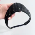 Detailed view of elegant black retro headband with gold and black sequin embroidery. - Black Striped Sequin Style