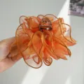 Close-up detail of the elegant orange ruffled mesh fabric on a stylish hair claw clip. - Mesh Pleated Claw Clip / Orange