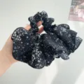 Detailed view of a retro black and white floral pleated oversized scrunchie hair accessory. - Black Polka Dot Floral