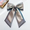 Detailed macro shot of an iridescent organza bow hair clip with flowing long streamers - Bowknot Spring Clip / Blue