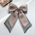 Detailed view of the elegant layered organza and iridescent satin ribbon bow hair clip accessory. - Bow Spring Clip / Gray