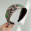 Close-up of bohemian embroidered wide headband with vintage ethnic pattern in green and red. - Wide Headband / Black With Lines