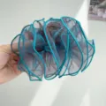 Close-up detail of a large ruffled teal blue mesh hair claw clip for women's hairstyle - Mesh Pleated Claw Clip / Blue