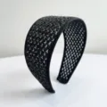 Detailed close-up showing the intricate texture of this black woven wide headband accessory - Black