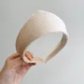 Macro view of the soft beige velvet texture on a vintage style padded headband - Beige