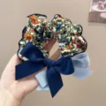 Close-up of a floral scrunchie with navy and light blue bow detail for hair styling. - L / Botanical Print Bow Hair Tie