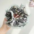Detailed view of oversized pleated hair scrunchie with mint green tulle ruffles - White With Print Mesh Edge