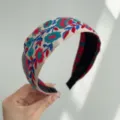 Close-up of bohemian wide headband with vibrant red and blue floral embroidery - Wide Headband / Red Green Floral