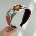 Close-up detail of bohemian style wide headband with vibrant floral embroidery patterns - Wide Headband / Yellow Floral