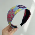 Detailed view of bohemian style light blue fabric headband with colorful floral embroidery - Wide Headband / Blue Purple Floral
