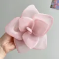 Detailed view of large pink mesh rose flower hair clip with delicate petal layers - Pink