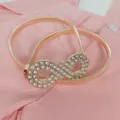 Rose gold metallic elastic waist belt with rhinestone infinity buckle for dresses and sweaters. - Style 1: Gold-Tone Belt with Figure 8 Buckle