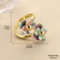Détail macro d'une bague dorée ornée de deux fleurs en émail coloré dégradé. - 活口双花朵戒指 / 开口指环(高2.6cmx宽2.1cm)