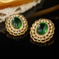 Detailed view of vintage palace style gold earrings with large oval green gemstones - Large Oval Green Gem Rhinestone Hollow Border Style (E4-19424B-7500)