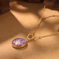 Detailed macro shot of a vintage gold necklace featuring a rose and purple enamel pendant. - Rose Zodiac Flower Necklace (2-27144A-N-6500)