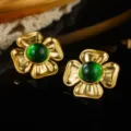 Macro detail shot of vintage gold flower earrings featuring elegant emerald green centers. - Four-Petal Radial Green Core Style (E4-19909B-5000)