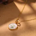 Close-up of vintage gold birth flower necklace pendant with holly leaf design - Holly Zodiac Flower Necklace (2-27146A-N-6500)