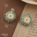 Detailed close-up of vintage teal enamel earrings with golden floral patterns and gems - Blue-Green Enamel Rhinestone Floral Style (E4-20347D-5000)