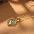 Detail view of vintage palace style gold necklace featuring a floral enamel pendant - Dark Green Daisy Necklace (2-27225-N-6500)