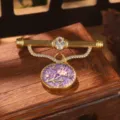 Detailed view of vintage palace style brooch featuring purple floral enamel and crystals - Purple Floral Brooch (2-27218-BR-7500)