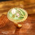 Detail view of vintage oil painting flower ring with pearl, showing size and weight. - Adjustable Open / Green Glaze Lily of the Valley (E4-21795A-JC-5000)