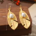 Boucles d'oreilles plumes dorées élégantes avec une perle ovale au centre - Boucles d'Oreilles Perle Plume Dorée (2-21916-5200)