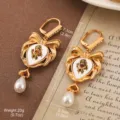 Vintage gold-tone bow earrings with skull motif and teardrop pearl pendant - Gothic Pearl Bow Skull Style (2-25339A-8500)