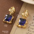Elegant vintage gold plated earrings featuring square deep blue crystal gemstone - Golden Irregular Texture with Blue Square Style (2-25951-8000)