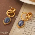 Vintage gold drop earrings featuring blue stones and textured interlocking rings design. - Hammered Blue Gemstone Interlocking Rings Style (E3-21025B-6000)