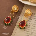 Vintage gold-tone drop earrings featuring large red teardrop stones and green bead accents - Ruby Color Water Drop Ear Clip Style (E4-21277A-7500)