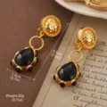 Vintage gold textured drop earrings with black teardrop pendant for a retro aesthetic - Black Water Drop Ear Clip Style (E4-21277B-7500)