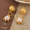 Vintage gold-tone pearl teardrop earrings with detailed textured floral metal design - Matte Gold Pearl Water Drop Ear Clip Style (E4-21277C-7500)
