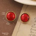 Elegant vintage round stud earrings featuring red faux stone and a gold-tone metallic rim - Red and Black Textured Round Stud Style (E4-21439-4500)