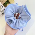 Close-up of large blue fabric scrunchie with blue and white striped edges - Striped Edge Scrunchie / Blue
