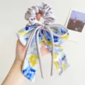 Detailed view of elegant purple scrunchie with artistic oil painting bow design. - Bow Ribbon with Scrunchie