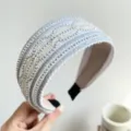 Close-up view of a wide white headband with silver beads and glitter stripes. - Wide Bead Stripe Shimmer Style / White