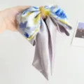 Close-up detail of an elegant oil painting style bow hair scrunchie with satin ribbons. - Crystal Ribbon Double Bow Hair Claw