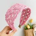 Close-up of pink wide woven rattan headband featuring a delicate hollow-out design - Braided Headband / Pink
